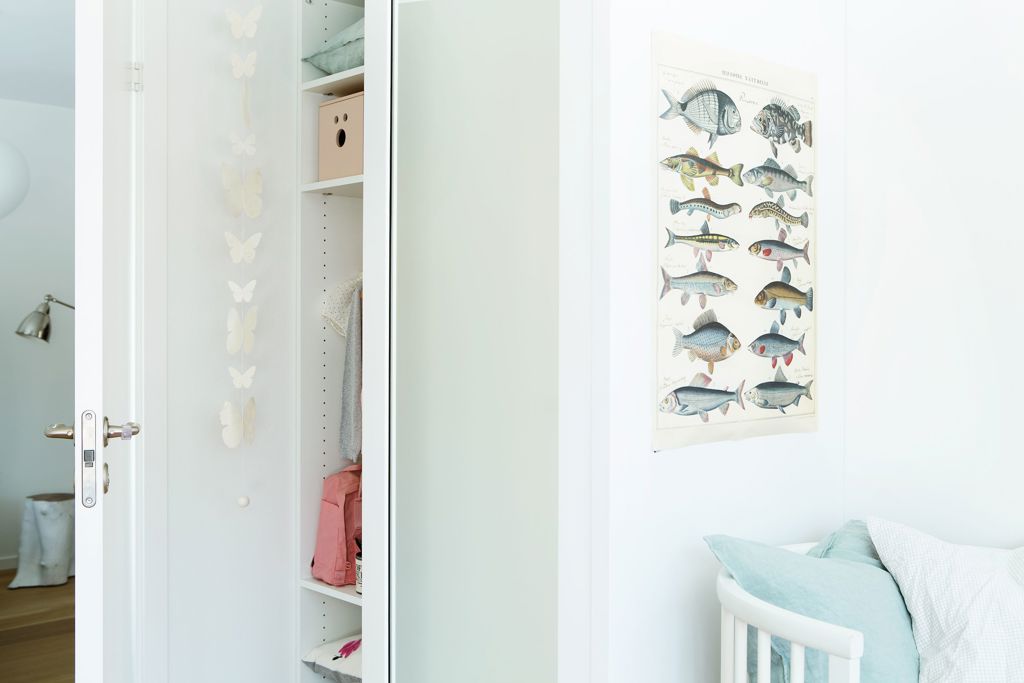 Closeup children`s room with Langlo® Topaz sliding wooden wardrobe doors in pure white finish